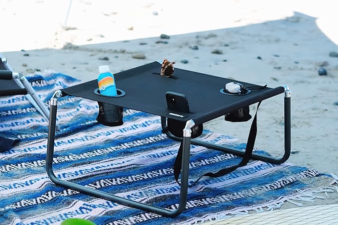 Neso Beach Table - Lightweight, Portable and Foldable Table for Beach, Camping and Outdoor Adventures - Stable Surface - with Cup Holder for Drinks and Phone Pockets - Black