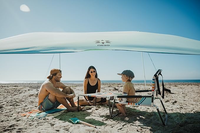 Neso Beach Table - Lightweight, Portable and Foldable Table for Beach, Camping and Outdoor Adventures - Stable Surface - with Cup Holder for Drinks and Phone Pockets - Rainbow