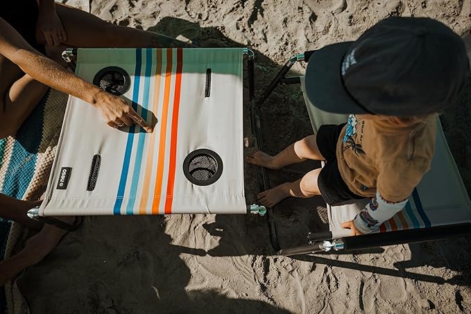 Neso Beach Table - Lightweight, Portable and Foldable Table for Beach, Camping and Outdoor Adventures - Stable Surface - with Cup Holder for Drinks and Phone Pockets - Rainbow